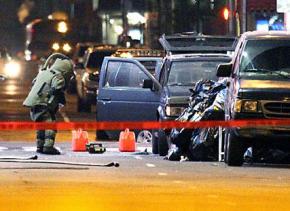 An explosives technician investigates the SUV found in Times Square in New York City