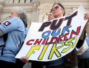 A teacher from San Francisco joins in protests against budget cuts in Sacramento in March
